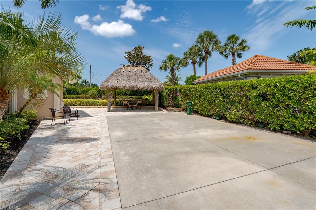 13419 Snook Circle Naples, FL 34114 - Photo 18 of 34 a view of a garden with a patio