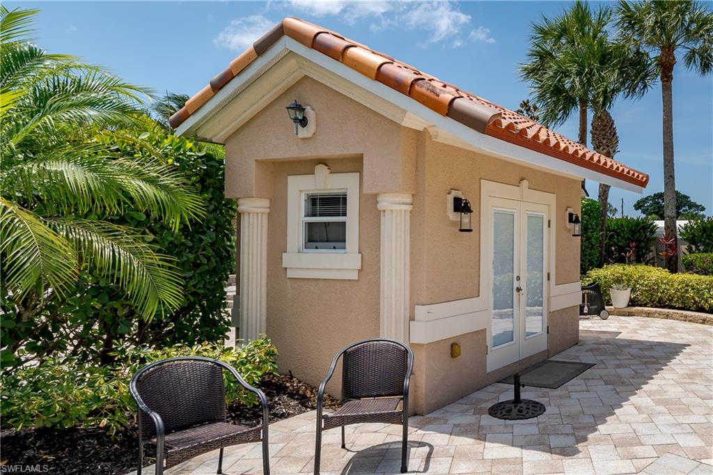 13419 Snook Circle Naples, FL 34114 - Photo 2 of 34 a front view of house with yard outdoor seating and barbeque oven