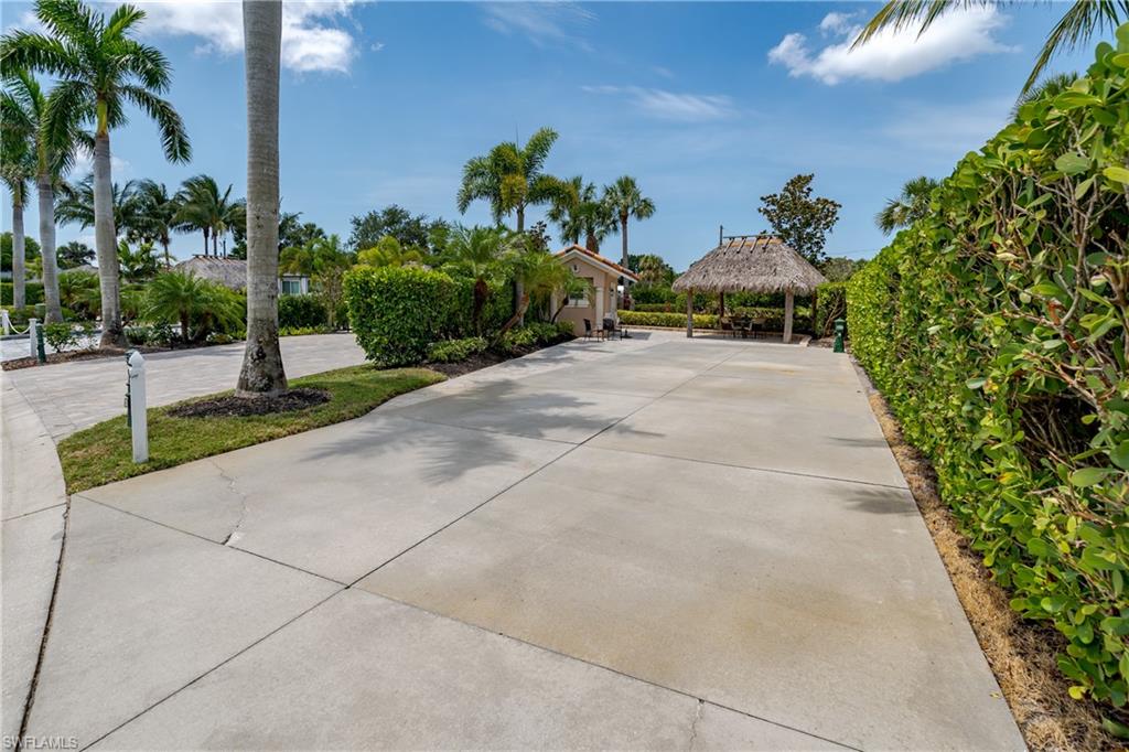 13419 Snook Circle Naples, FL 34114 - Photo 26 of 34 a view of a garden with a pathway