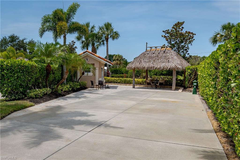 13419 Snook Circle Naples, FL 34114 - Photo 27 of 34 a view of a street with a building and palm trees