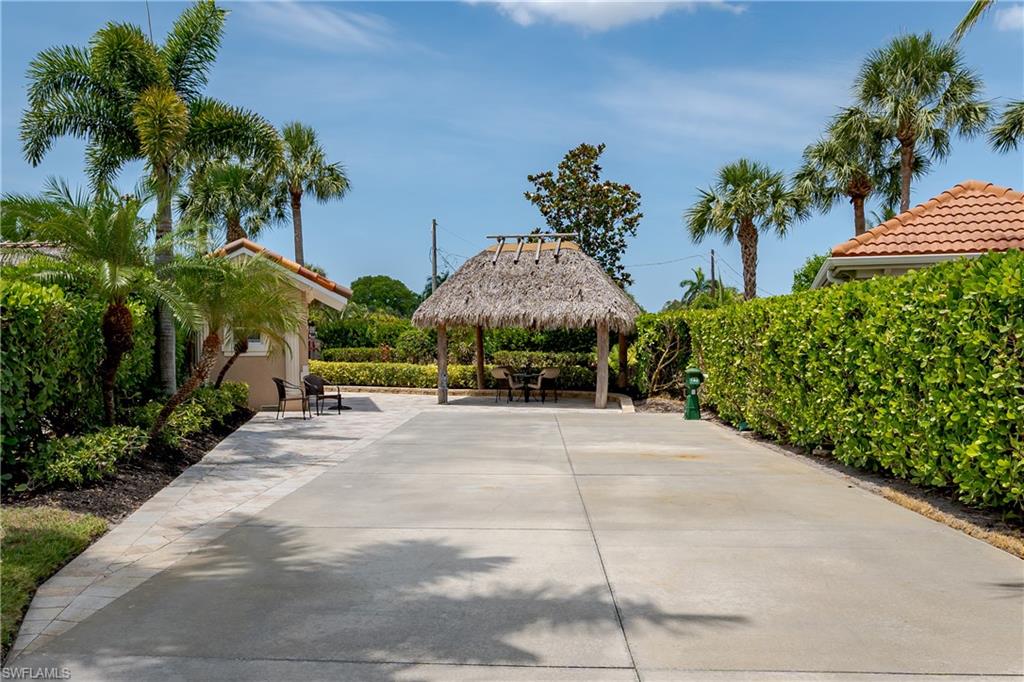 13419 Snook Circle Naples, FL 34114 - Photo 28 of 34 a view of a garden with a pathway