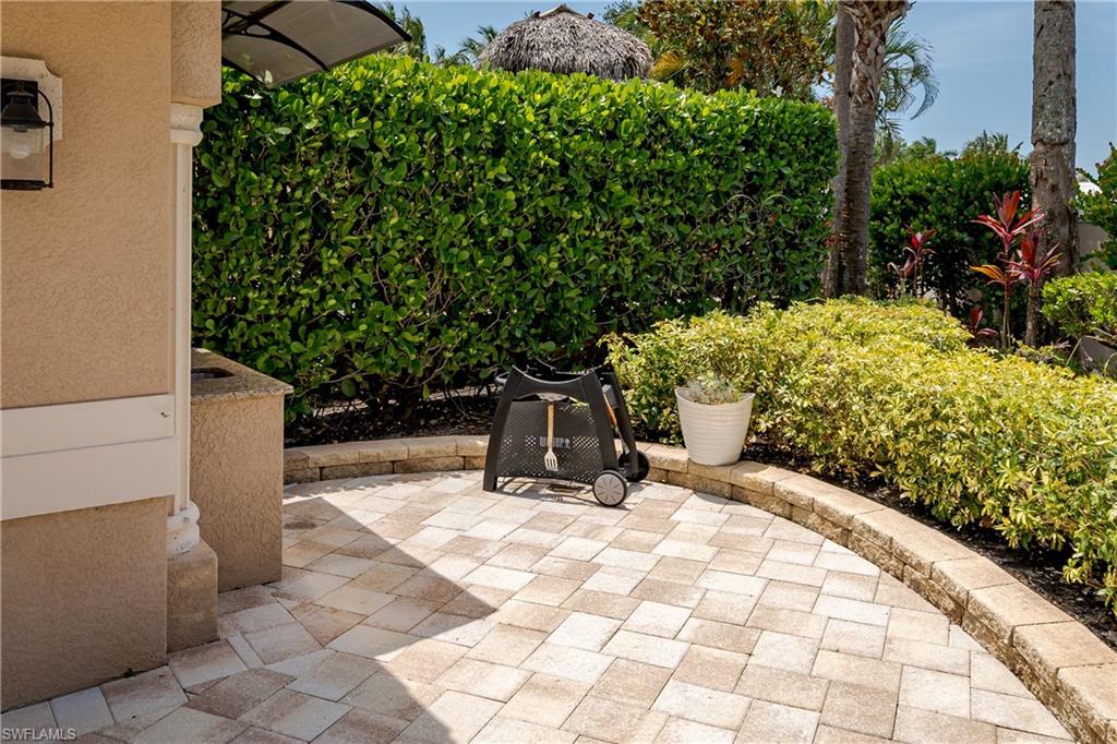13419 Snook Circle Naples, FL 34114 - Photo 4 of 34 a view of a chairs and bench in the backyard of a house