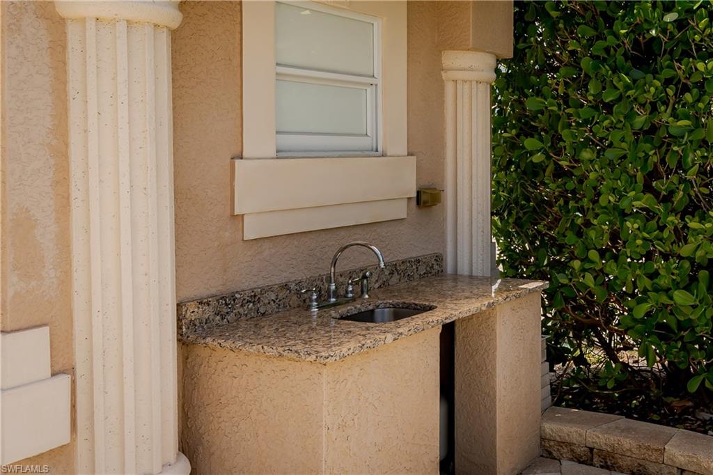 13419 Snook Circle Naples, FL 34114 - Photo 6 of 34 a bathroom with a granite countertop sink and a mirror
