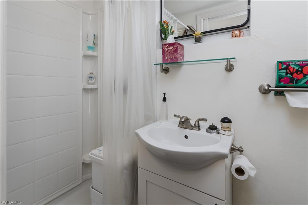 13419 Snook Circle Naples, FL 34114 - Photo 9 of 34 a bathroom with a sink and mirror