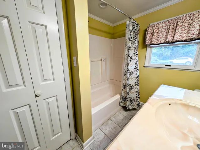 a bathroom with a tub and shower