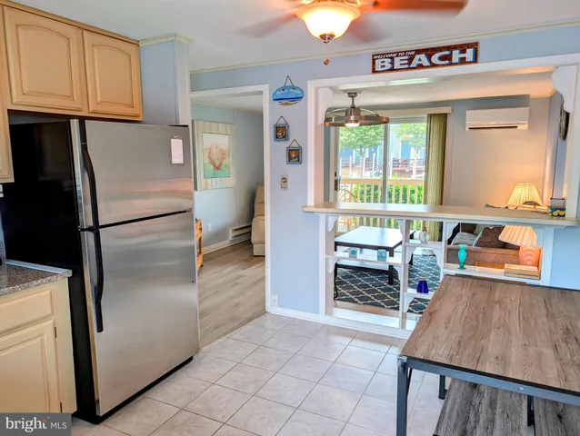 a kitchen with stainless steel appliances granite countertop a refrigerator a stove and a sink with cabinets
