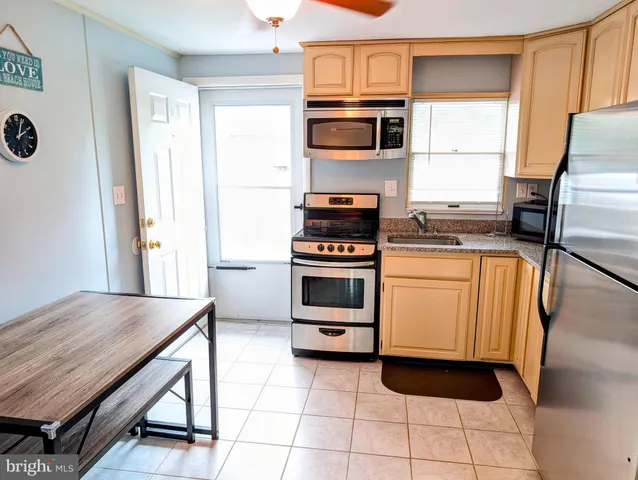 a kitchen with a stove a sink and a refrigerator