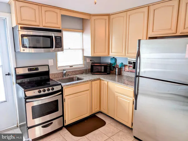 a kitchen with a refrigerator stove and microwave
