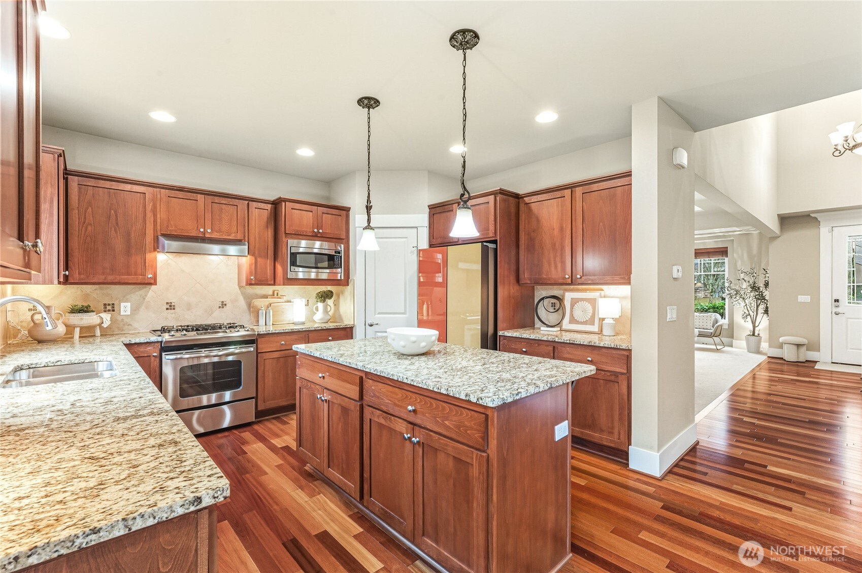 5205 Northeast 10th Street Renton, WA 98059 - Photo 9 of 28 a kitchen with stainless steel appliances granite countertop wooden cabinets sink and stove