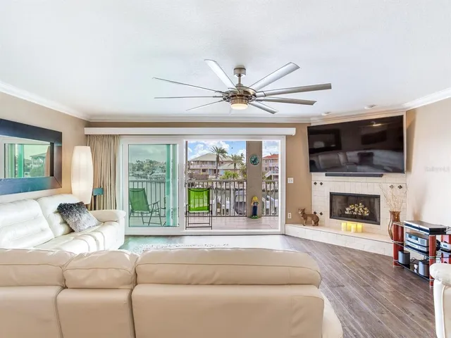 a bedroom with a bed and a view of living room