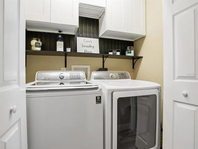 a kitchen with stainless steel appliances granite countertop dining table chairs refrigerator and microwave