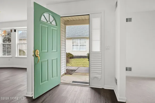 a view of an entryway with wooden floor and door