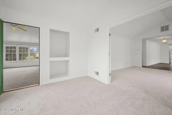 an empty room with windows and closet