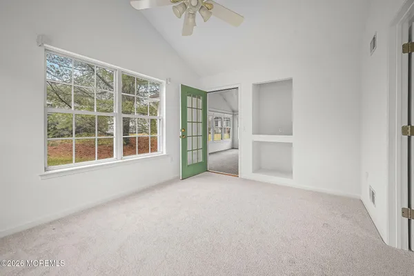 an empty room with a empty space and windows