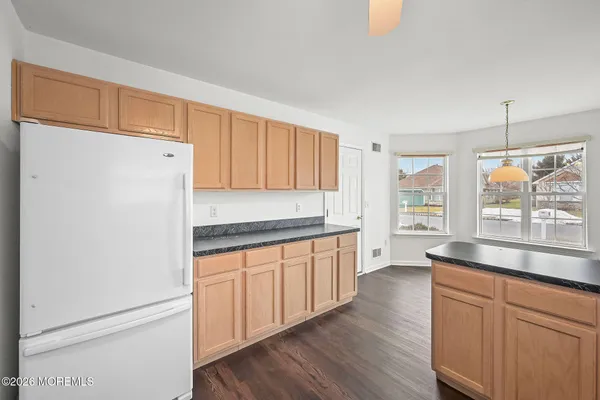 a kitchen with counter top space and wooden floor