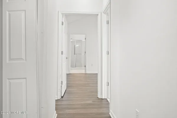 a view of a hallway with wooden floor