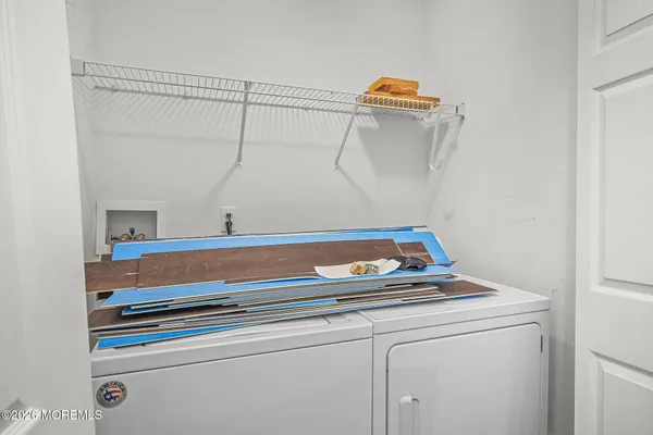 a close view of laundry room with cabinets and washer