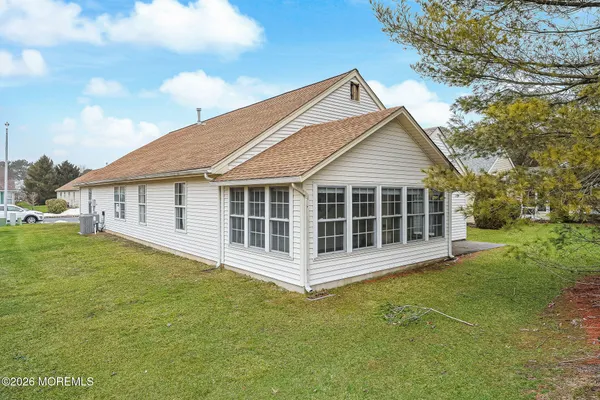 a view of a house with yard and tree s