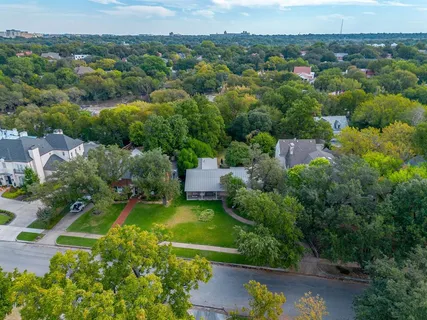 an aerial view of a house with a yard