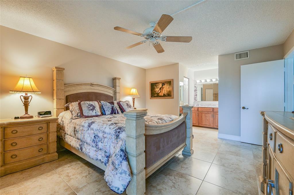 3650 Environ Boulevard, Unit 401 Lauderhill, FL 33319 - Photo 22 of 59 a bedroom with a bed and a chandelier