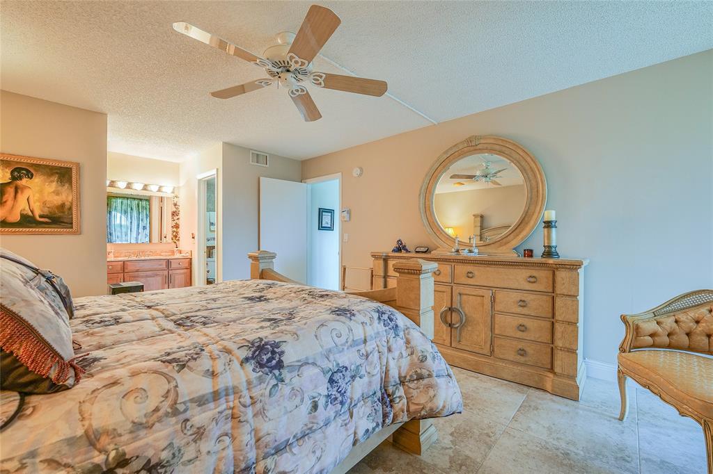 3650 Environ Boulevard, Unit 401 Lauderhill, FL 33319 - Photo 23 of 59 a bedroom with a bed and a dresser