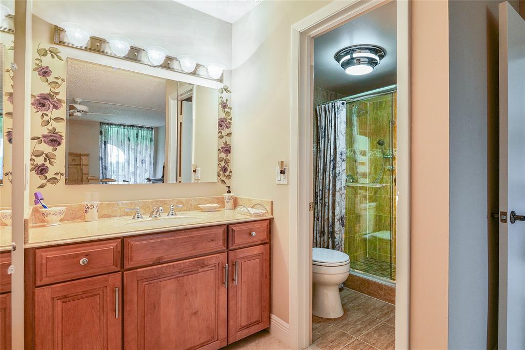 3650 Environ Boulevard, Unit 401 Lauderhill, FL 33319 - Photo 24 of 59 a bathroom with a toilet a sink and a mirror