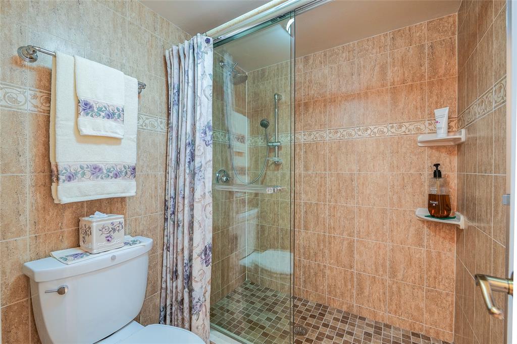 3650 Environ Boulevard, Unit 401 Lauderhill, FL 33319 - Photo 25 of 59 a bathroom with a toilet a sink and shower
