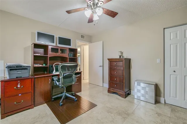 a view of a hallway with wooden floor and cabinet