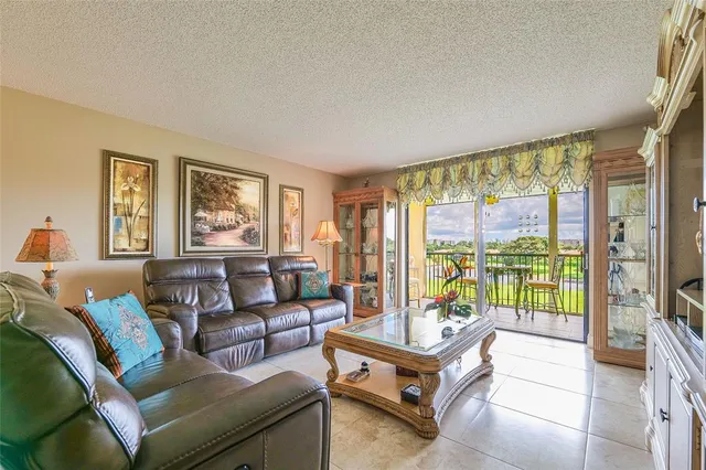 a living room with furniture and a floor to ceiling window
