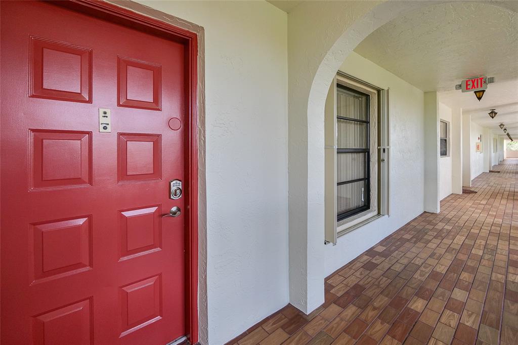 3650 Environ Boulevard, Unit 401 Lauderhill, FL 33319 - Photo 35 of 59 a view of a hallway with wooden floor and cabinet