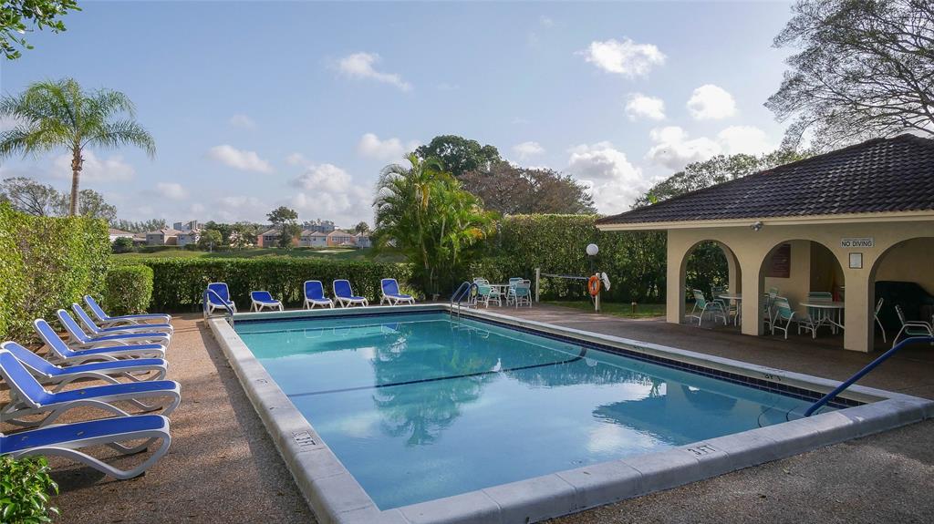3650 Environ Boulevard, Unit 401 Lauderhill, FL 33319 - Photo 43 of 59 a view of a swimming pool with a lounge chairs