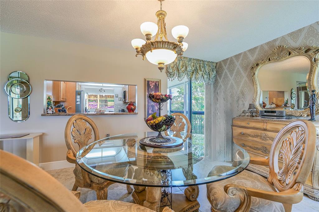3650 Environ Boulevard, Unit 401 Lauderhill, FL 33319 - Photo 8 of 59 a dining room with furniture a chandelier and wooden floor