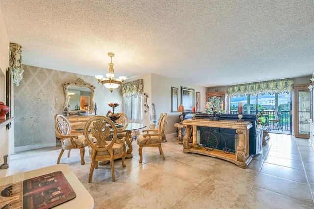 a living room with furniture a dining table and a fireplace