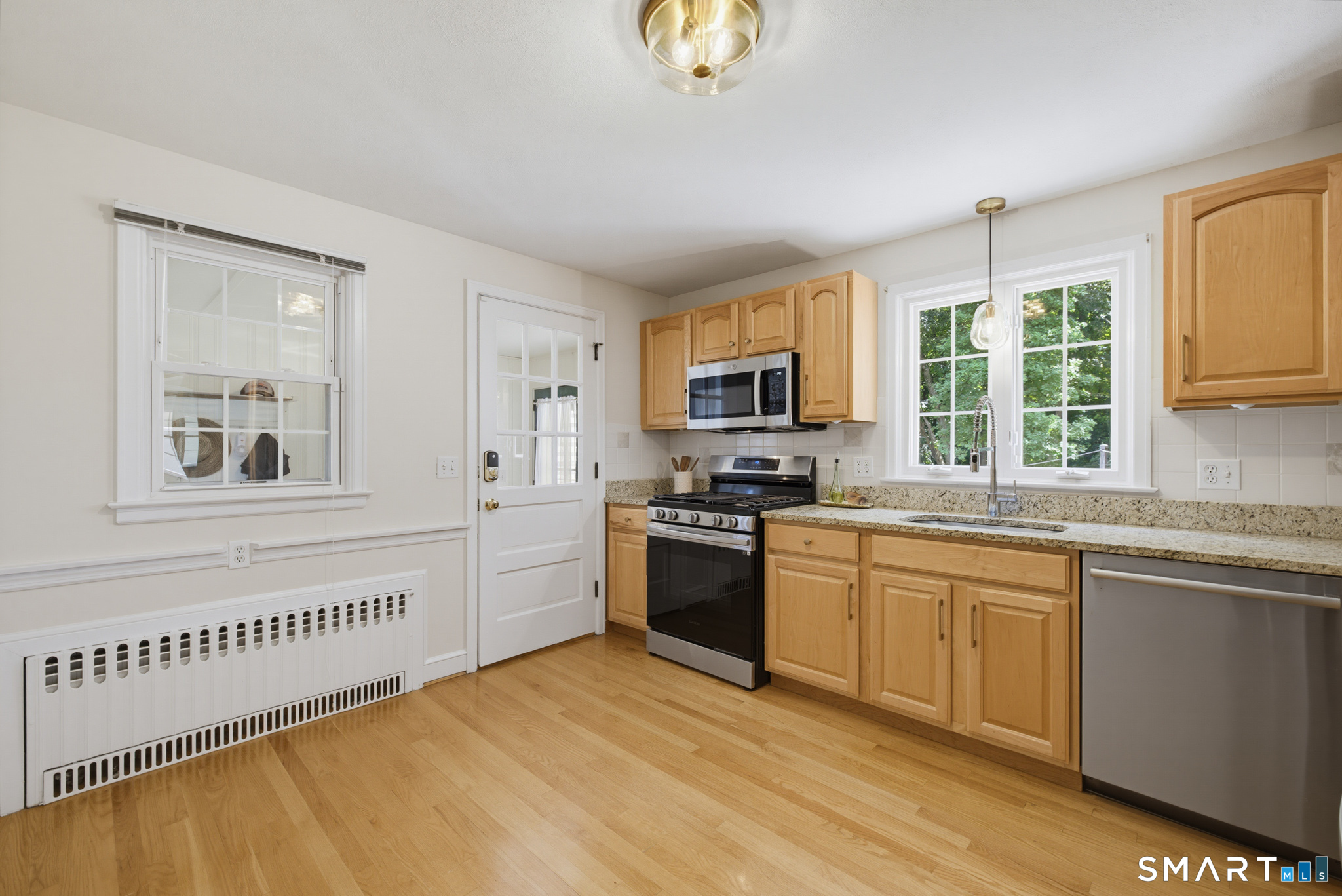 224 Spring Street Manchester, CT 06040 - Photo 10 of 39 a kitchen with stainless steel appliances granite countertop a stove a sink dishwasher a refrigerator and a microwave oven with white cabinets