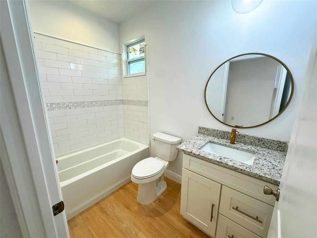 8297 Strasse Boulevard Punta Gorda, FL 33982 - Photo 14 of 31 a bathroom with a granite countertop toilet a sink and a mirror