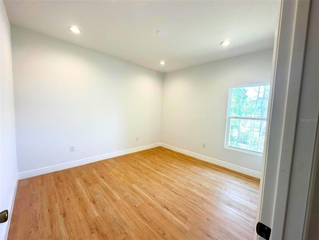 8297 Strasse Boulevard Punta Gorda, FL 33982 - Photo 25 of 31 an empty room with wooden floor and windows