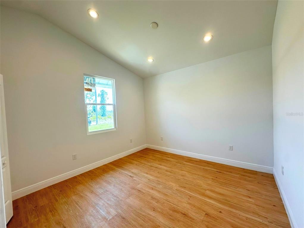 8297 Strasse Boulevard Punta Gorda, FL 33982 - Photo 27 of 31 an empty room with wooden floor and windows