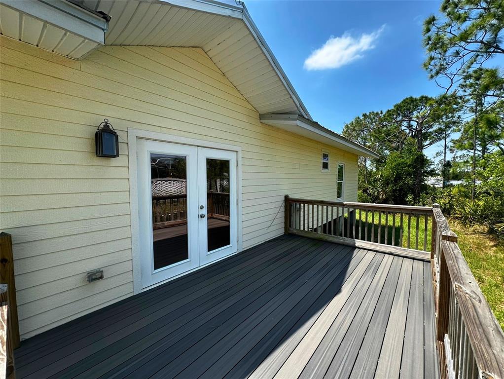 8297 Strasse Boulevard Punta Gorda, FL 33982 - Photo 8 of 31 a view of deck with wooden floor and fence with a floor to ceiling window