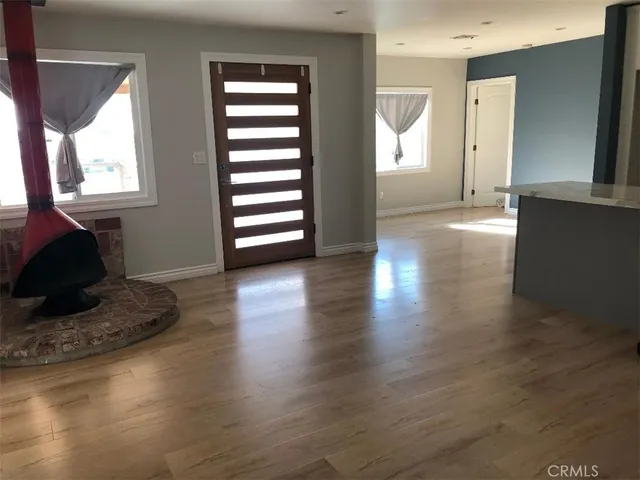 a view of a livingroom with wooden floor and a window