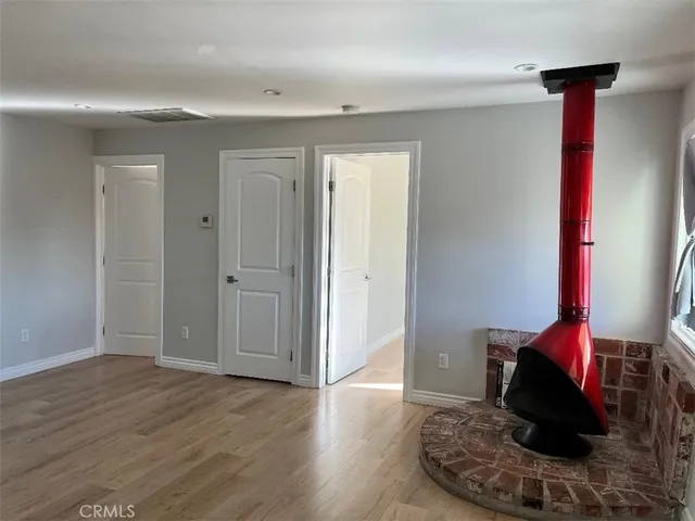 a view of a hallway with wooden floor and chair