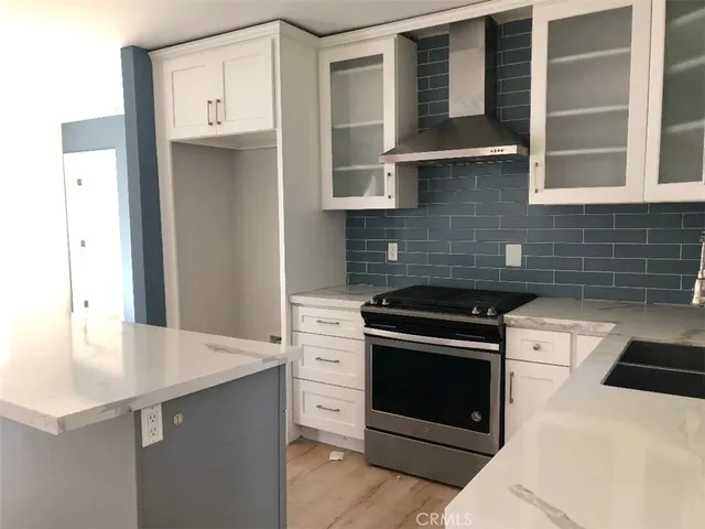 a kitchen with stainless steel appliances a stove and a refrigerator