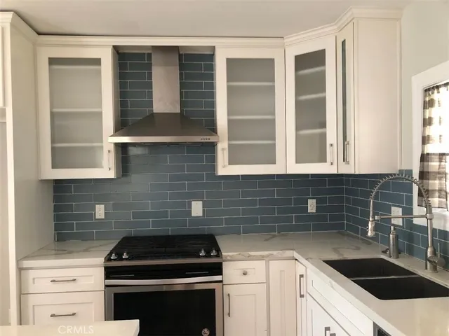 a kitchen with granite countertop a sink and a stove