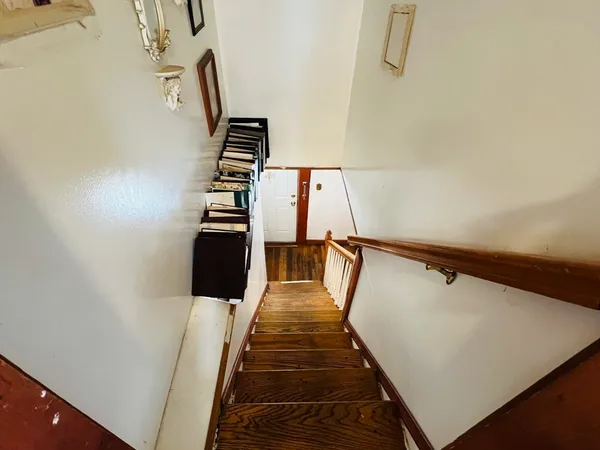 a view of entryway and hall with wooden floor