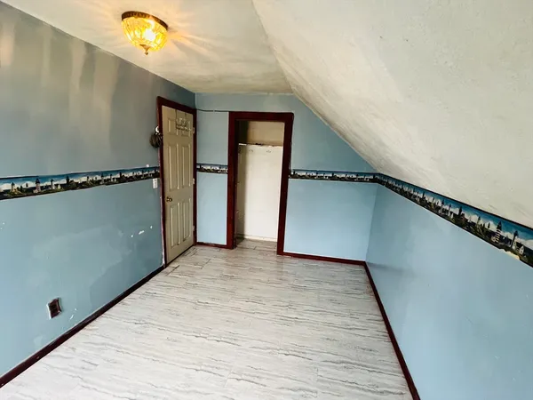 a view of a room with wooden floor and staircase