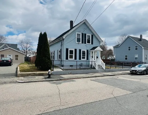 a front view of a house with a parking space