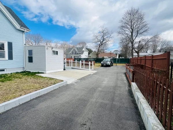 a view of a house with a wooden fence