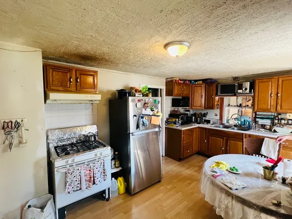 a kitchen with refrigerator and window