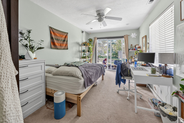 730 East 200 North Logan, UT 84321 - Photo 21 of 28 Room featuring light-colored carpeting, a ceiling fan, and sliding glass doors providing access to the exterior