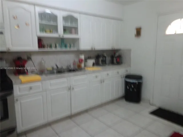 a kitchen with a cabinets and wooden floor
