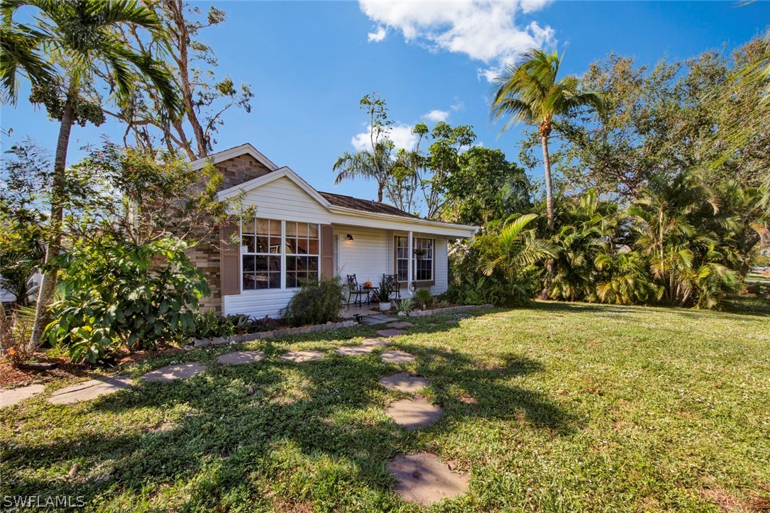 18442 Sunflower Road Fort Myers, FL 33967 - Photo 3 of 26 a front view of a house with garden